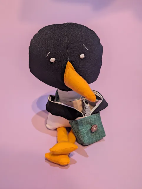 Penguin with green bag
